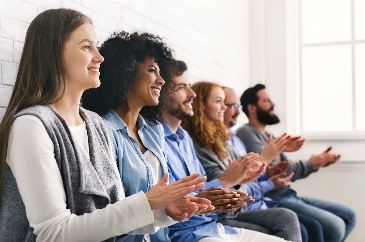 A group of people clapping their hands together